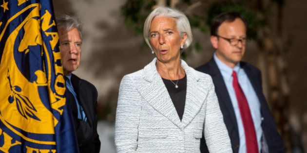 WASHINGTON, DC - APRIL 30, 2014: International Monetary Fund Managing Director Christine Lagarde, center, walks with IMF chief spokesman Gerry Rice, left, before announcing a two-year 'Stand-By Arrangement' for Ukraine at IMF headquarters on April 30, 2014 in Washington D.C. The IMF intends for the $17 billion fund to restore stability and launch economic growth in the country. (Photo by Allison Shelley/Getty Images)