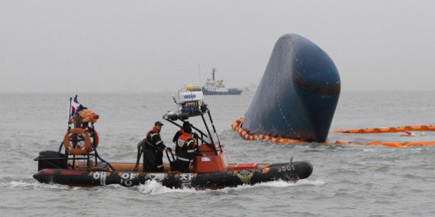 JINDO-GUN, SOUTH KOREA - APRIL 17: South Korean Coast Guard and rescue teams search for missing passengers at the site of the sunken ferry off the coast of Jindo Island on April 17, 2014 in Jindo-gun, South Korea. At least six people are reported dead, with 290 still missing. The ferry identified as the Sewol was carrying about 470 passengers, including students and teachers, traveling to Jeju Island. (Photo by Chung Sung-Jun/Getty Images)