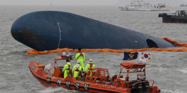 JINDO-GUN, SOUTH KOREA - APRIL 17: South Korean Coast Guard and rescue teams search for missing passengers at the site of the sunken ferry off the coast of Jindo Island on April 17, 2014 in Jindo-gun, South Korea. At least six people are reported dead, with 290 still missing. The ferry identified as the Sewol was carrying about 470 passengers, including students and teachers, traveling to Jeju Island. (Photo by Chung Sung-Jun/Getty Images)