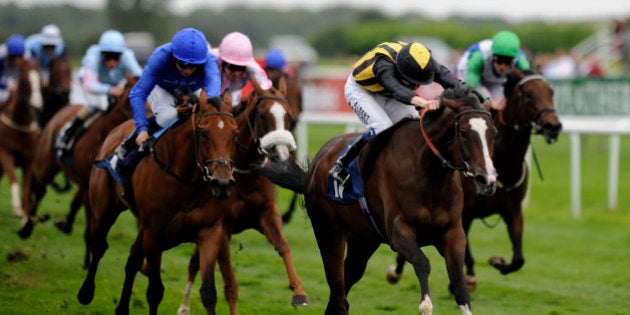 DONCASTER, ENGLAND - SEPTEMBER 13: Jamie Spencer riding Sunday Times (C) win The Japan Racing Association Sceptre Stakes at Doncaster racecourse on September 13, 2012 in Doncaster, England. (Photo by Alan Crowhurst/Getty Images)