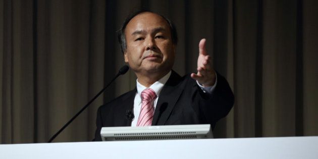 Billionaire Masayoshi Son, chairman and chief executive officer of SoftBank Corp., gestures to a reporter during a news conference in Tokyo, Japan, on Wednesday, Feb. 12, 2014. SoftBank posted third-quarter profit that beat analyst estimates as the release of Apple Inc.'s new iPhones spurred the addition of 2.3 million subscribers. Photographer: Tomohiro Ohsumi/Bloomberg via Getty Images