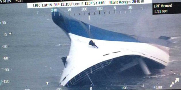 JINDO-GUN, SOUTH KOREA - APRIL 16: In this screen shot handout of helicopter camera provided by the Republic of Korea Coat Guard, the ferry is seen sinking as the rescue work continues off the coast of Jindo Island on April 16, 2014 in Jindo-gun, South Korea. Two people are dead, and more than ninety are missing as reported. The ferry identified as the Sewol was carrying about 470 passengers, including the students and teachers, traveling to Jeju island. (Photo by The Republic of Korea Coast Guard via Getty Images)