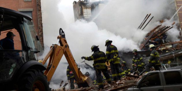 NEW YORK, NY - MARCH 12: In this image handout provided by the Office of Mayor of New York, firefighters from the Fire Department of New York (FDNY) use an excavator to remove rubble as they respond to a five-alarm fire and building collapse at 1646 Park Ave in the Harlem neighborhood of Manhattan March 12, 2014 in New York City. Reports of an explosion were heard before the collapse of two multiple-dwelling buildings at East 116th St. and Park Avenue that left at least 17 injured and a number of people are missing. (Photo by Rob Bennett/Office of Mayor of New York/Getty Images)