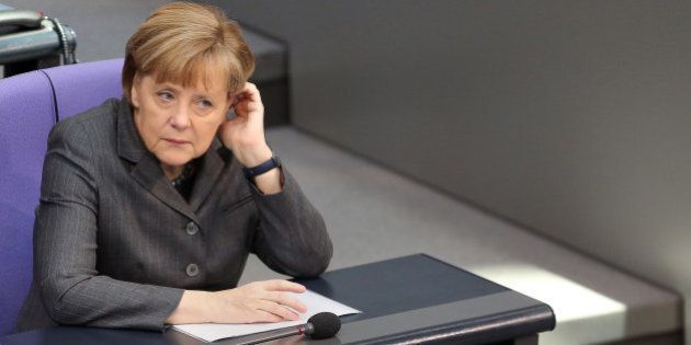 BERLIN, GERMANY - FEBRUARY 13: German Chancellor Angela Merkel attends a meeting of the Bundestag, or German federal Parliament, on February 13, 2014 in Berlin, Germany. In a government policy statement, or Regierungserklaerung, Vice Chancellor and Economy and Energy Minister Sigmar Gabriel (SPD) said he wants to see more financial strengthening of German cities and local communities, as well as an 8.50 EUR an hour minimum wage, a proposal met with opposition by Sahra Wagenknecht of the Left party (Die Linken), who insisted that 10 EUR an hour is a fairer salary. (Photo by Adam Berry/Getty Images)