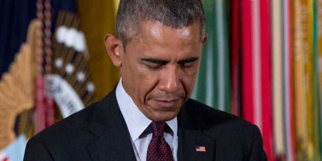 President Barack Obama bows his head in prayer in the East Room of the White House in Washington, Tuesday, June 2, 2015, before posthumously bestowing the Medal Of Honor on Army Sgt. William Shemin and Army Pvt. Henry Johnson during a ceremony. Two World War I Army heroes, one black, one Jewish, are finally getting the Medal of Honor they may have been denied because of discrimination, nearly 100 years after bravely rescuing comrades on the battlefields of France. (AP Photo/Carolyn Kaster)