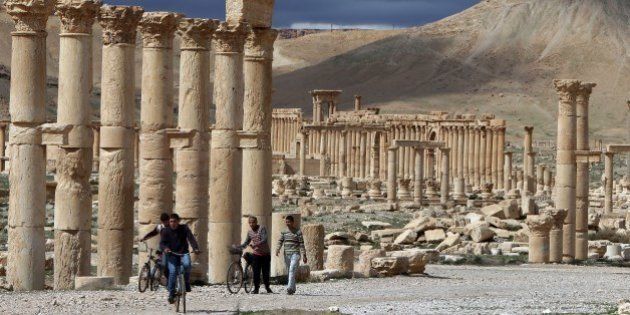 A picture taken on March 14, 2014 shows Syrian citizens riding their bicycles the ancient oasis city of Palmyra, 215 kilometres northeast of Damascus. From the 1st to the 2nd century, the art and architecture of Palmyra, standing at the crossroads of several civilizations, married Graeco-Roman techniques with local traditions and Persian influences. AFP PHOTO/JOSEPH EID (Photo credit should read JOSEPH EID/AFP/Getty Images)
