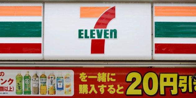 A woman enters a 7-Eleven convenience store, operated by Seven & I Holdings Co., in Kawasaki City, Kanagawa Prefecture, Japan, on Tuesday, May 28, 2013. Seven & I, the operator of 7-Eleven convenience stores, plans more acquisitions in the U.S. and may more than double North America outlets as consumer spending improves in the largest economy. Photographer: Akio Kon/Bloomberg via Getty Images