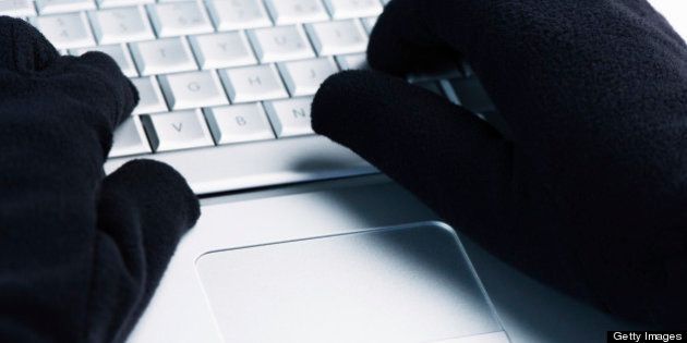 IT Crime consept Hacker works on laptop