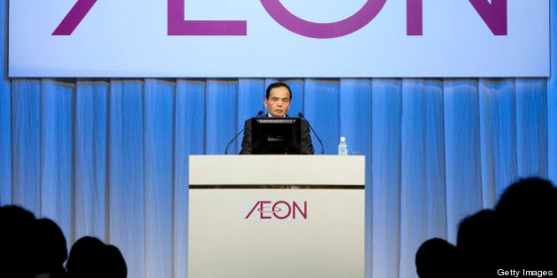 Motoya Okada, president and chief executive officer of Aeon Co., speaks during an induction ceremony for the company's new hires in Chiba City, Japan, on Sunday, April 1, 2012. Aeon Co. is Japan's largest supermarket operator. Photographer: Tomohiro Ohsumi/Bloomberg via Getty Images