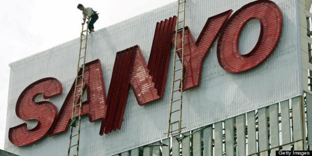 Hanoi, VIET NAM: A worker climbs atop an advertising billboard for Japanese company Sanyo, being installed in downtown Hanoi, 18 October 2006. Vietnamese Prime Minister Nguyen Tan Dung has left Hanoi 18 October for Japan for a five-day official visit aimed at boosting further trade ties which Hanoi expects to reach around 10 billion USD this year. AFP PHOTO/HOANG DINH Nam (Photo credit should read HOANG DINH NAM/AFP/Getty Images)