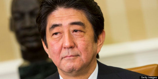 Shinzo Abe, Japan's prime minister, sits during a meeting with U.S. President Barack Obama, not pictured, in the Oval Office of the White House in Washington, D.C., U.S., on Friday, Feb. 22, 2013. Abe is seeking to bolster his country's key alliance as a bulwark against China's territorial claims and North Korea's nuclear ambitions. Photographer: Kristoffer Tripplaar/Pool via Bloomberg