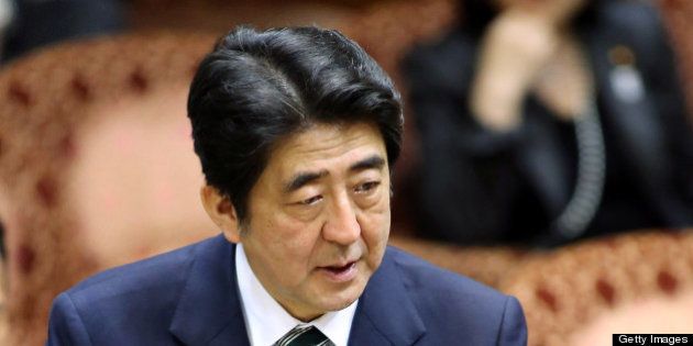 Shinzo Abe, Japan's prime minister, speaks during a budget committee session at the upper house of parliament in Tokyo, Japan, on Wednesday, Feb. 20, 2013. Abe said that the need to buy foreign bonds has decreased, backing away from a policy proposal that may be seen by other nations as a direct attempt to weaken the yen. Photographer: Haruyoshi Yamaguchi/Bloomberg via Getty Images