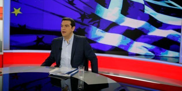 Greece's Prime Minister Alexis Tsipras prepares for a TV interview at the State Television (ERT) in Athens, Monday, June 29, 2015. Anxious pensioners swarmed closed bank branches Monday and long lines snaked at ATMs as Greeks endured the first day of serious controls on their daily economic lives ahead of a July 5 referendum that could determine whether the country has to ditch the euro currency and return to the drachma. (AP Photo/Thanassis Stavrakis)