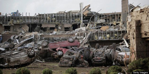 MOORE, OK- MAY 20: Flipped vehicles are piled up outside the heavily damaged Moore Medical Center after a powerful tornado ripped through the area on May 20, 2013 in Moore, Oklahoma. The tornado, reported to be at least EF4 strength and two miles wide, touched down in the Oklahoma City area on Monday killing at least 51 people. (Photo by Brett Deering/Getty Images)