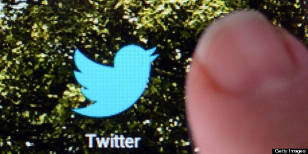 A picture taken on October 23, 2012 in Rennes, western France, shows a finger touching the screen of a handheld device that features a logo of the micro-blogging site Twitter. AFP PHOTO DAMIEN MEYER (Photo credit should read DAMIEN MEYER/AFP/Getty Images)