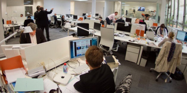 Journalists work inside the newsroom of new French media company 'L'Opinion', which aims to be a daily online newspaper also sold in print form five days a week, as well as an online news app and a webtv, in Paris, on May 6, 2013. The launch of the new newspaper will be on May 14, according to the CEO. AFP PHOTO / LIONEL BONAVENTURE (Photo credit should read LIONEL BONAVENTURE/AFP/Getty Images)