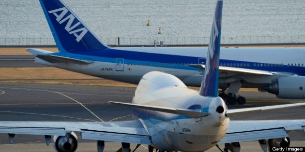 A Boeing Co. 747-400 aircraft, front, and a Boeing Co. 777-200 aircraft, both operated by All Nippon Airways Co. (ANA), line up on the runway prior to take off at Haneda Airport in Tokyo, Japan, on Wednesday, Jan. 30, 2013. ANA has canceled a total of 784 flights, affecting 74,200 passengers through Feb. 12, since a Jan. 16 incident that led to the global grounding of Boeing Co. 787s, according to figures from the company. Photographer: Akio Kon/Bloomberg via Getty Images