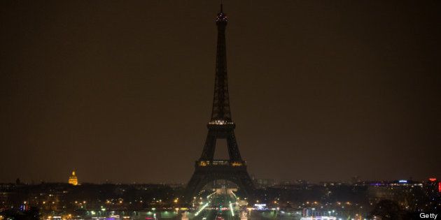 The Eiffel tower is seen before submerging into darkness at 8:30 pm (local time) as part of the Earth Hour switch-off on March 23, 2013 in Paris. Organisers expect hundreds of millions of people across more than 150 countries to turn off their lights for 60 minutes on Saturday night -- at 8:30 pm local time -- in a symbolic show of support for the planet. While more than 150 countries joined in last year's event, the movement has spread even further afield this year, with Palestine, Tunisia, Suriname and Rwanda among a host of newcomers pledging to take part. AFP PHOTO BERTRAND LANGLOIS (Photo credit should read BERTRAND LANGLOIS/AFP/Getty Images)