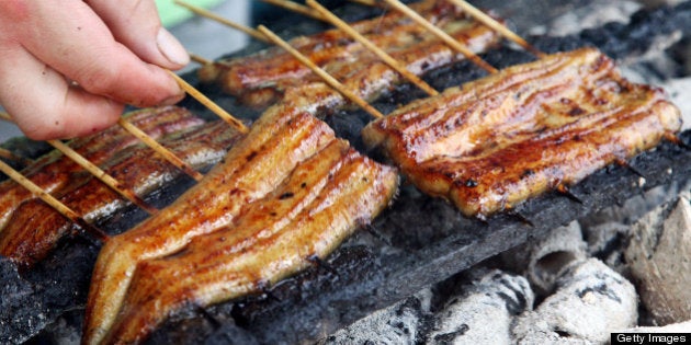 Spitchcocked eels are grilled at a restaurant in Tokyo, Japan, on Thursday, July 19, 2012. The U.S. government is considering regulating the international trade of some eel species under the Washington Convention next year. The movement could push up eel prices in Japan. Photographer: Haruyoshi Yamaguchi/Bloomberg via Getty Images