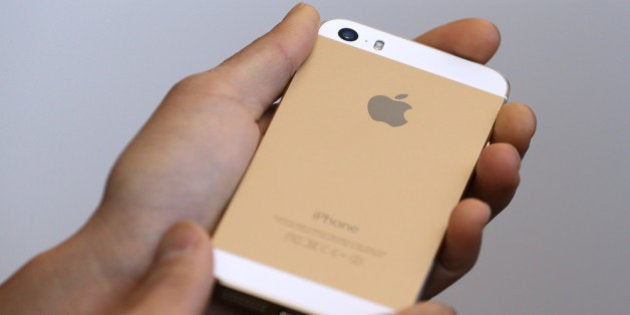 CUPERTINO, CA - SEPTEMBER 10: The new iPhone 5S is displayed during an Apple product announcement at the Apple campus on September 10, 2013 in Cupertino, California. The company launched the new iPhone 5C model that will run iOS 7 is made from hard-coated polycarbonate and comes in various colors and the iPhone 5S that features fingerprint recognition security. (Photo by Justin Sullivan/Getty Images)