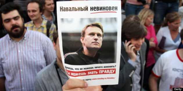 A protester holds a portrait of opposition leader Alexei Navalny, sentenced to five years in a penal colony after finding him guilty of embezzlement in a timber deal, on July 18, 2013 during a demonstration in central Moscow. Judge Sergei Blinov said he found Navalny guilty of colluding to steal money in a timber deal while acting as an unpaid advisor to the local government in the northern Kirov region. AFP PHOTO / IVAN NOVIKOV (Photo credit should read IVAN NOVIKOV/AFP/Getty Images)