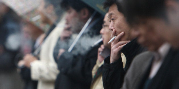 People smoke cigarettes in Tokyo, Japan, on Friday, Dec. 11, 2009. Yoshiyasu Okihira, an analyst at Credit Suisse, said on Dec. 4 he expects the Japanese government to raise tobacco taxes by 40-60 yen a pack after a media report by the Mainichi Daily News. Photographer: Tomohiro Ohsumi/Bloomberg via Getty Images