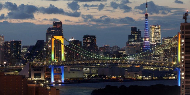 The Rainbow Bridge is illuminated in front of the Tokyo Tower at dusk in Tokyo, Japan, on Tuesday, Sept. 3, 2013. Tokyo is the odds-on favorite to host the 2020 Olympic Games in the days before the winning city is announced, according to bookmakers. Photographer: Tomohiro Ohsumi/Bloomberg via Getty Images