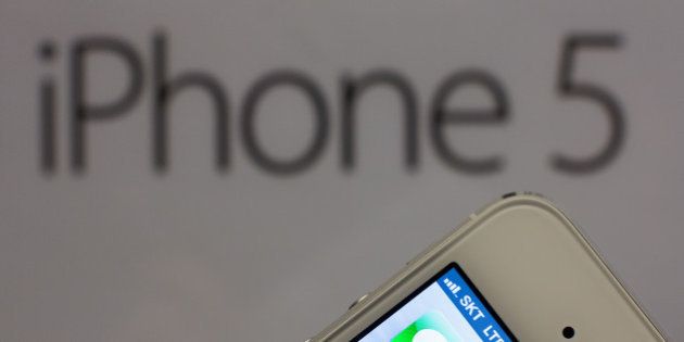 An Apple Inc. iPhone 5 is arranged for a photograph during a launch event organized by SK Telecom Co. in Seoul, South Korea, on Friday, Dec. 7, 2012. The iPhone 5 went on sale in South Korea today. Photographer: SeongJoon Cho/Bloomberg via Getty Images