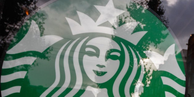 A logo sits on display in a window of a Starbucks Corp. store in Amsterdam, Netherlands, on Monday, Sept. 16, 2013. Global coffee supplies will outpace demand for a second year in the 2013-14 season that starts in October in most countries because of ample availability of arabica, according to Volcafe Ltd. Photographer: Jasper Juinen/Bloomberg via Getty Images