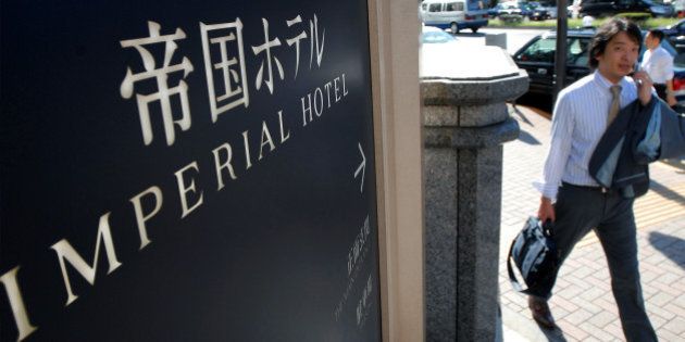 JAPAN - SEPTEMBER 21: A man walks past a sign outside the Imperial Hotel in Tokyo, Japan, on Friday, Sept. 21, 2007. Mitsui Fudosan Co., Japan's biggest real estate company, may buy a stake in Imperial Hotel Ltd., owner of the 117-year-old hotel, expanding in central Tokyo as commercial land prices advance for the first time since 1991. (Photo by Robert Gilhooly/Bloomberg via Getty Images)