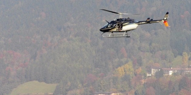 TEGERNSEE, GERMANY - OCTOBER 11: A helicopter with a film camera crew circles above lake Tegernsee after...