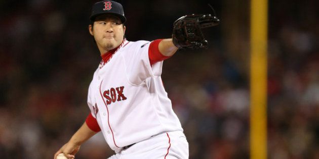 BOSTON, MA - OCTOBER 23: Junichi Tazawa #36 of the Boston Red Sox pitches against the St. Louis Cardinals in the eighth inning of Game One of the 2013 World Series at Fenway Park on October 23, 2013 in Boston, Massachusetts. (Photo by Rob Carr/Getty Images)