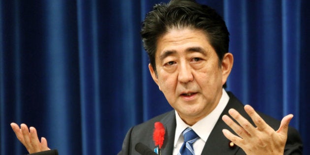 Shinzo Abe, Japan's prime minister, gestures during a news conference at the prime minister's official residence in Tokyo, Japan, on Tuesday, Oct. 1, 2013. Abe proceeded with an April sales-tax increase and will implement a stimulus program as he tries to rein in the world's biggest debt burden without jeopardizing efforts to end deflation. Photographer: Haruyoshi Yamaguchi/Bloomberg via Getty Images