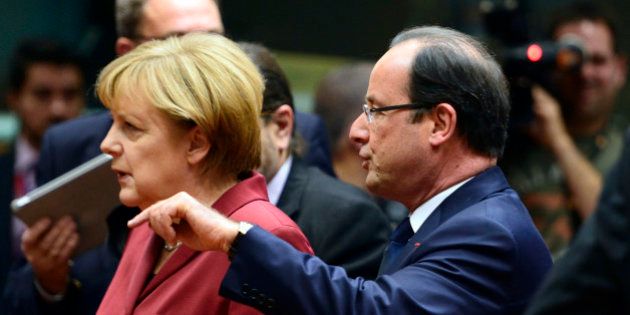 French President Francois Hollande (R) talks on October 24, 2013 with German Chancellor Angela Merkel before the start of a European Council meeting at the EU headquarters in Brussels. European Union heads of state and government open a two-day summit on OCtober 24, focusing notably on prospects for growth from the digital economy amid data privacy concerns, plus lessons from the Lampedusa migrant tragedy. AFP PHOTO / ERIC FEFERBERG (Photo credit should read ERIC FEFERBERG/AFP/Getty Images)