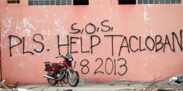 TACLOBAN, PHILIPPINES - NOVEMBER 13: A message seeking help is written on the wall of destroyed building...