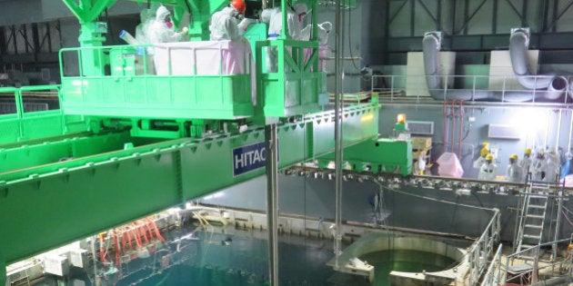 OKUMA, JAPAN - NOVEMBER 18: In this handout image provided by Tokyo Electric Power Co, workers remove nuclear fuel rods from a pool at No. 4 reactor of the Fukushima Daiichi Nuclear Power Plant on November 18, 2013 in Okuma, Fukushima, Japan. TEPCO started removing nuclear fuel from a damaged reactor building for the first time, marking a new stage in the decades-long decommissioning process. The operation to empty the storage pool in the No. 4 reactor building, which holds 1,533 nuclear fuel assemblies, began and expected to be removed by December 2014. But the overall decommissioning work at the stricken nuclear plant is expected to take 30 to 40 years to complete. (Photo by Tokyo Electric Power Co via Getty Images)