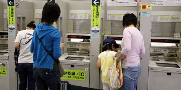 JAPAN - MAY 21: Customers use a Sumitomo Mitsui Bank's ATM in Tokyo, Japan, on Monday, May 21, 2007. Sumitomo Mitsui Banking Corp., the main banking unit of Japan's third-biggest lender by market value, paid a premium to sell 80 billion yen ($714 million) of bonds (Photo by Haruyoshi Yamaguchi/Bloomberg via Getty Images)