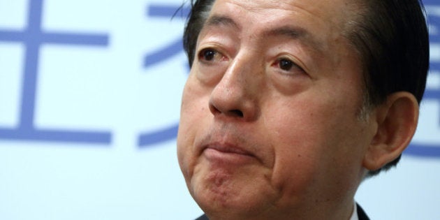 Akihiro Ohta, Japan's minister of land, infrastructure, transport and tourism, listens during a news...