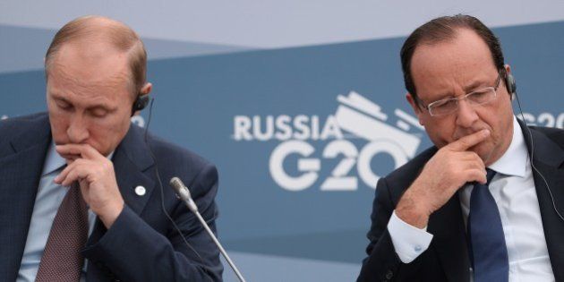 SAINT PETERSBURG - SEPTEMBER 06: President of the Russian Federation Vladimir Putin, (L) and President of France, Francois Hollande attend a meeting with Business 20 and Labour 20 representatives during the G20 summit on September 6, 2013 in St. Petersburg, Russia. Leaders of the G20 nations made progress on tightening up on multinational company tax avoidance, but remain divided over the Syrian conflict as they enter the final day of the Russian summit. (Photo by Alexey Filippov /Host Photo Agency via Getty Images)