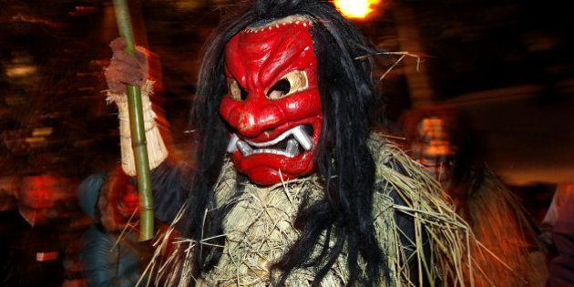 OGA, JAPAN - FEBRUARY 13: A man dressed in straw clothes and an orge mask as Namahage, or a mountain demon, marches through the grounds of the shrine during the Namahage Sedo Festival at Shinzan Shrine on February 13, 2010 in Oga, Akita, Japan. Namahage visit each house to admonish sluggards to mend their ways, ward off disasters and offer blessings, looking for evil children, in the region on New Year's Eve. In the festival, which combines the local event of the ceremony of the shrine, visitors can experience these traditions and its folk culture. (Photo by Kiyoshi Ota/Getty Images)