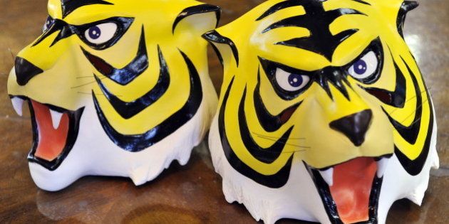 Rubber masks of cartoon character 'Tiger Mask' a masked professional wrestling manga hero is displayed at Japanese toy mask maker Ogawa Rubber's headquaters in Saitama city, suburban Tokyo on January 13, 2011. Japan has been enthralled by the mysterious comeback of a 1960s manga comic book hero that has sparked a nationwide wave of gift-giving by anonymous donors to underprivileged children. The spate of donations started on Christmas Day, when presents were left at a children's welfare centre near Tokyo, with a note saying they came from 'Naoto Date', the alter ego of professional wrestling character 'Tiger Mask'. The widely reported gift struck a chord with Japanese who fondly remember Tiger Mask -- an orphan-turned-fighter who helped other parentless children -- and has sparked more than 30 copycat acts of generosity since, Kyodo News said. AFP PHOTO / Yoshikazu TSUNO (Photo credit should read YOSHIKAZU TSUNO/AFP/Getty Images)