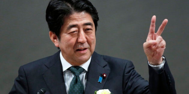 Shinzo Abe, Japan's prime minister, gestures as he speaks during a meeting at the business lobby Keidanren in Tokyo, Japan, on Wednesday, Dec. 25, 2013. Japan unveiled a record budget for the next fiscal year on Dec. 22, as Abe boosts spending on social security, defense and public works while trying to contain the growth of the world's biggest debt burden. Photographer: Kiyoshi Ota/Bloomberg via Getty Images