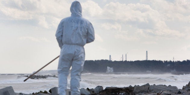 NAMIE, FUKUSHIMA PREFECTURE - FEBRUARY 27: Police search Ukedo beach, within sight of the crippled Fukushima Daiichi nuclear plant, for the bodies of victims, over 2,000 still missing, since the 2011 tsunami and earthquake, on February 27, 2012 in Namie, Fukushima prefecture, Japan. Ukedo beach lies within the evacuated and now uninhabited 20km exclusion zone which is in force around the stricken nuclear plant. The exclusion zone used to be home to approximately 73,000 people but all have been evacuated by the government and are now restricted from returning home due to high levels of radioactive contamination from the explosions at the TEPCO owned Fukushima Daiichi nuclear plant following the earthquake and tsunami of March 11 2011. (Photo by Jeremy Sutton-Hibbert/Getty Images)