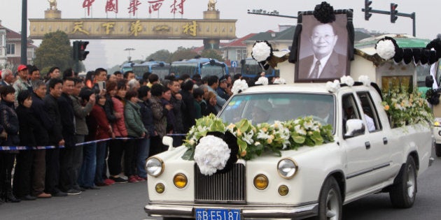 JIANGYIN, CHINA - MARCH 22: (CHINA OUT) A decorated hearse carrying the body of Wu Renbao, the former secretary of Huaxi Village Communist Party Committee, moves around Huaxi village on March 22, 2013 in Jiangyin, China. 85-year-old Wu Renbao died of cancer on Monday at his home in Huaxi village, one of China's richest villages, Jiangyin City of east China's Jiangsu Province. (Photo by ChinaFotoPress/ChinaFotoPress via Getty Images)