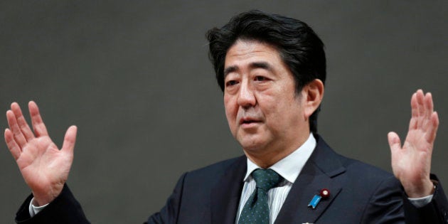 Shinzo Abe, Japan's prime minister, gestures as he speaks during a meeting at the business lobby Keidanren in Tokyo, Japan, on Wednesday, Dec. 25, 2013. Japan unveiled a record budget for the next fiscal year on Dec. 22, as Abe boosts spending on social security, defense and public works while trying to contain the growth of the world's biggest debt burden. Photographer: Kiyoshi Ota/Bloomberg via Getty Images