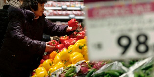 A customer browses capsicums at the Aeon Style Store in the Aeon Mall Makuhari Shintoshin shopping mall, operated by Aeon Mall Co., in Chiba, Japan, on Friday, Dec. 20, 2013. The mall opened today. Photographer: Kiyoshi Ota/Bloomberg via Getty Images