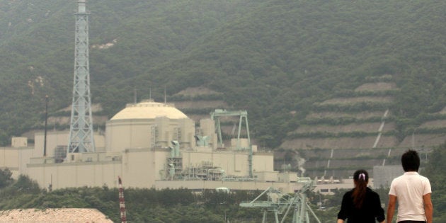 TSURUGA, JAPAN - JUNE 10: A couple walk beside the Monju nuclear reactor, one day before the three month anniversary of Japan's earthquake and tsunami on June 10, 2011 in Tsuruga, Japan. The Japanese government has been struggling to deal with the devastation caused by the magnitude 9 earthquake and tsunami, as well as the troubled Fukushima Daiichi Nuclear Power Plant. The fears of an outbreak of infectious diseases are mounting due to the impending humid rainy season combined with the delay in clearing the debris. (Photo by Buddhika Weerasinghe/Getty Images)