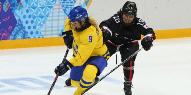 SOCHI, RUSSIA - FEBRUARY 09: Josefine Holmgren #9 of Sweden is challenged by Miho Shishiuchi #19 of Japan during the Women's Ice Hockey Preliminary Round Group B Game between Sweden and Japan on day 2 of the Sochi 2014 Winter Olympics at Shayba Arena on February 9, 2014 in Sochi, Russia. (Photo by Robert Cianflone/Getty Images)