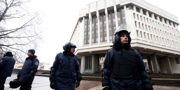 SIMFEROPOL, UKRAINE - FEBRUARY 27: Two different groups of around 60 armed men raided and occupied the regional government and parliament buildings in Simferopol, the capital of the Autonomous Republic of Crimea on February 27, 2014. Police forces take tightened security measures in front of the parliament building. (Photo by Bulent Doruk/Anadolu Agency/Getty Images)