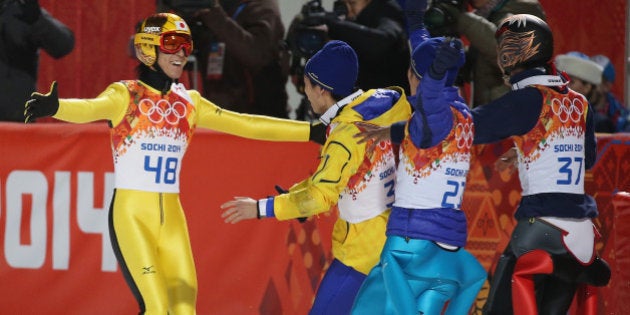 SOCHI, RUSSIA - FEBRUARY 15: Noriaki Kasai of Japan celebrates with team mates after winning the silver medal in the Ski Jumping Men's Large Hill Individual final round on day eight of the Sochi 2014 Winter Olympics at RusSki Gorki Jumping Center on February 15, 2014 in Sochi, Russia. (Photo by Robert Cianflone/Getty Images)